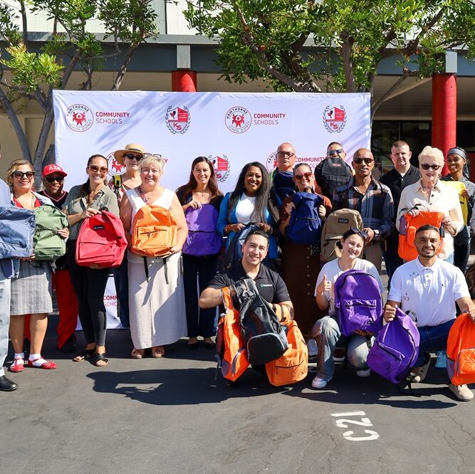 hawthorne chamber members posing at backpack drive participants posing